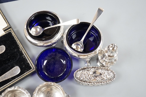 A pair of Victorian silver bun salts with blue glass liners and spoons, a spare liner, a later pair of small silver salts, a silver pepperette, a small silver box and a silver christening pair in box for three.